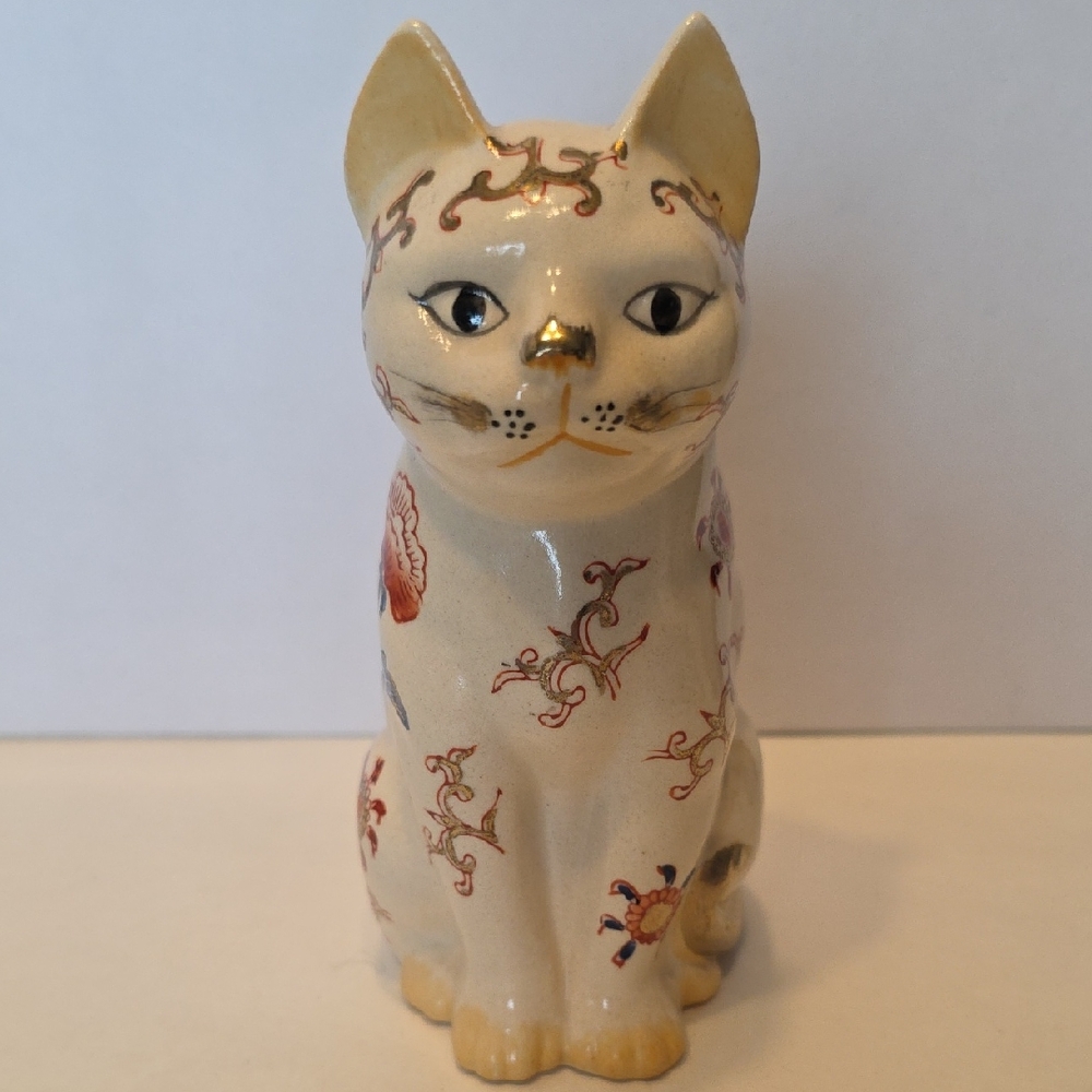 Vintage Japanese porcelain cat figurine referred to as Maneki-Neko or Lucky Cat